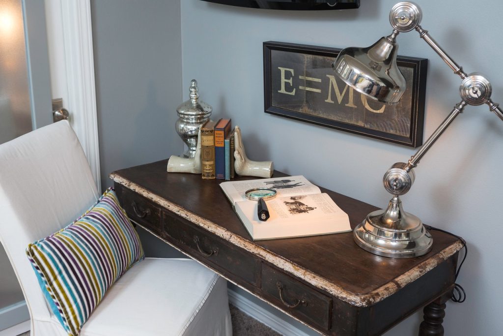 desk with magnifier, books organized