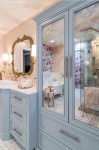 beautiful girl's bathroom remodel with blue vanity and gold and pink accents