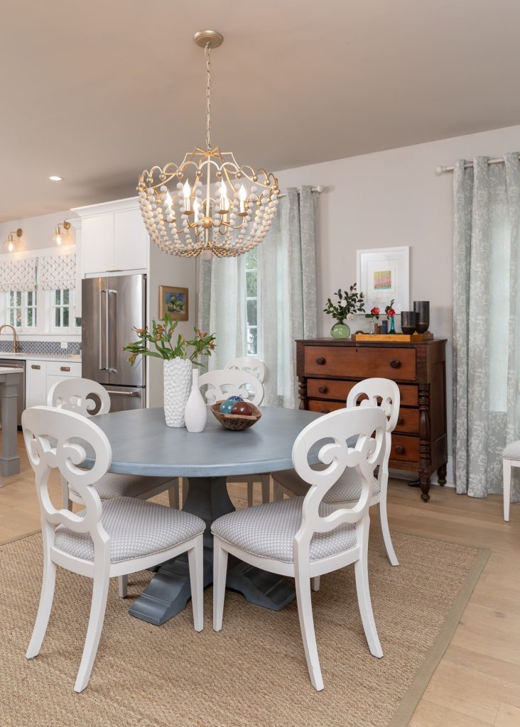 White and Blue Scandinavian Breakfast room with white chandelier and blue table