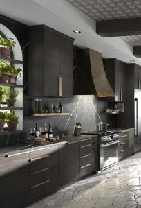 stone flooring, dark wood cabinets, black and white kitchen backsplash, natural materials, nature