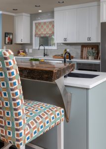 Live edge counter tops, patterned barstool, farmhouse kitchen